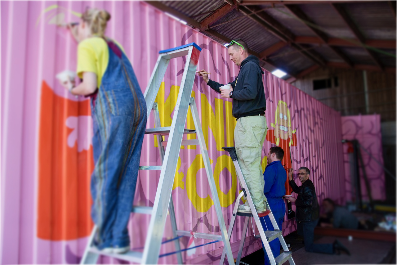 A discarded shipping container from ECS is transformed into an eye-catching artwork with some paint and a lot of helping hands.